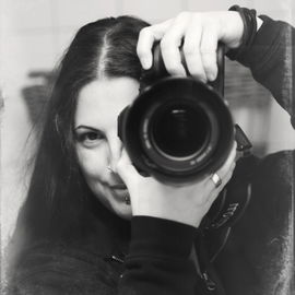 Behind the camera.
